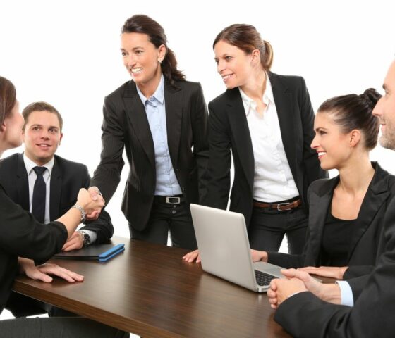 Group of Employees Talking at Table of Office with Workers Compensation Insurance in Concord, NC