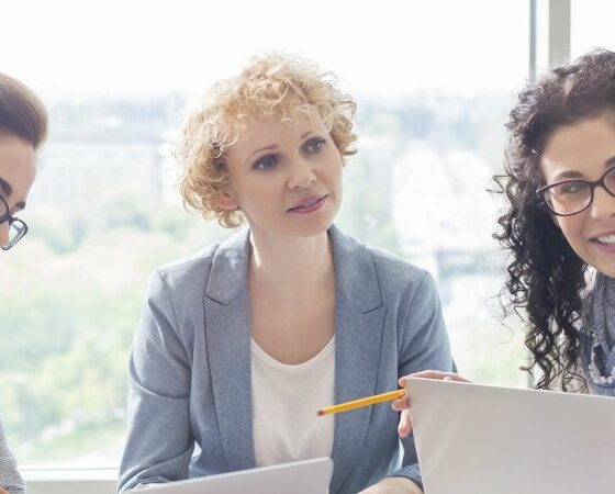 women at a table discussing Workers Compensation Insurance in Charlotte, Concord, NC, Gastonia, Matthews, NC, Fort Mill, SC